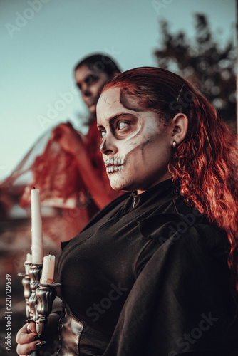 Eerie Halloween portrait of two people with skull face paint