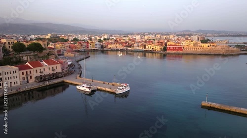  View of Chania with the amazing lighthouse, mosque, venetian shipyards, Crete, Greece.Waves crashing on lighthouse, Beautiful Greece and best scenic places - panorama