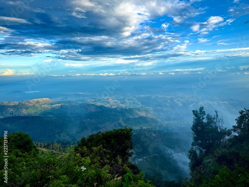 Photography High angle view of tropical green mountain landscape with cloudy sky