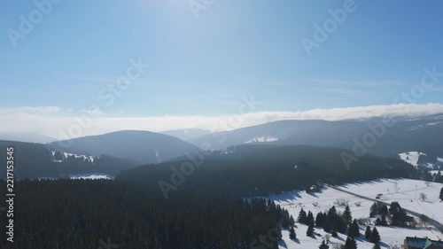 Snow-covered mountains in winter captured from an aerial view