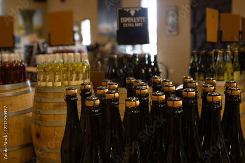 Obraz na plátně Numerous bottles of espumante sparkling wine with traditional corks and wire cages