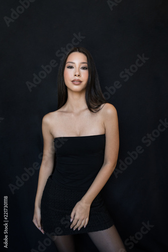 Beatiful Young Asian Woman with Long Dark Hair in Elegant Black Top Portrait