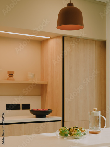 Bright minimalist Scandinavian kitchen interior with wooden cabinets and pendant light