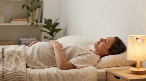 Woman Resting Peacefully in Bed in Cozy Sunlit Bedroom