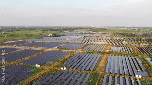 aerial view of solar panels arranged in agricultural fields