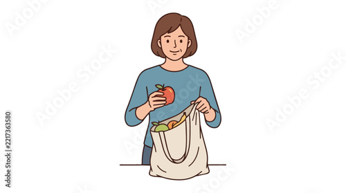 Woman unpacks fresh organic apples from a reusable grocery bag at the wooden kitchen table.
