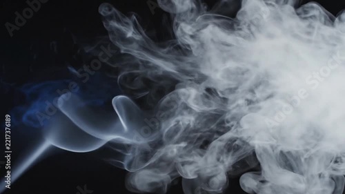 Smoke Stream Emerges in Dark Scene with Blue Lighting