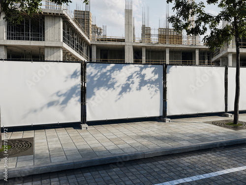Blank white banner mockup on construction hoarding with shadow overlay
