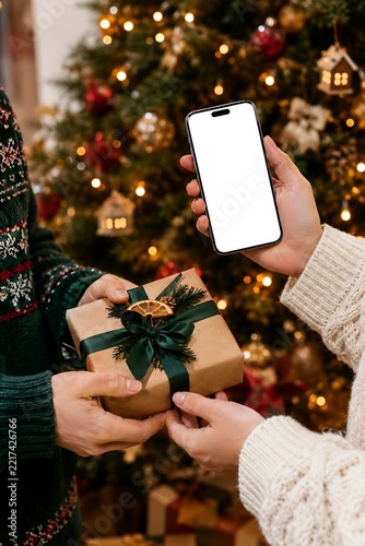 Smartphone mockup held during Christmas gift exchange tradition mockup ready to use