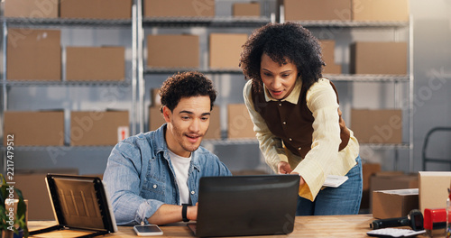 Team, laptop and cargo with people in warehouse for tracking review, logistics and sku information. Collaboration, ecommerce and shipping inventory report with employees for order verification