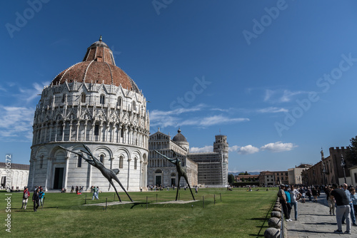 Pisa baptistery dome against blue sky in italy