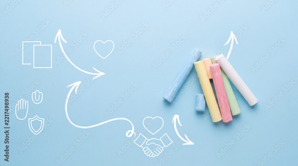 Fototapeta premium Top View of Colorful Chalk Sticks on Blue Background with White Line Art Icons Representing Strategy, Teamwork, Care, and Education Concept for Creative Business and School Presentation