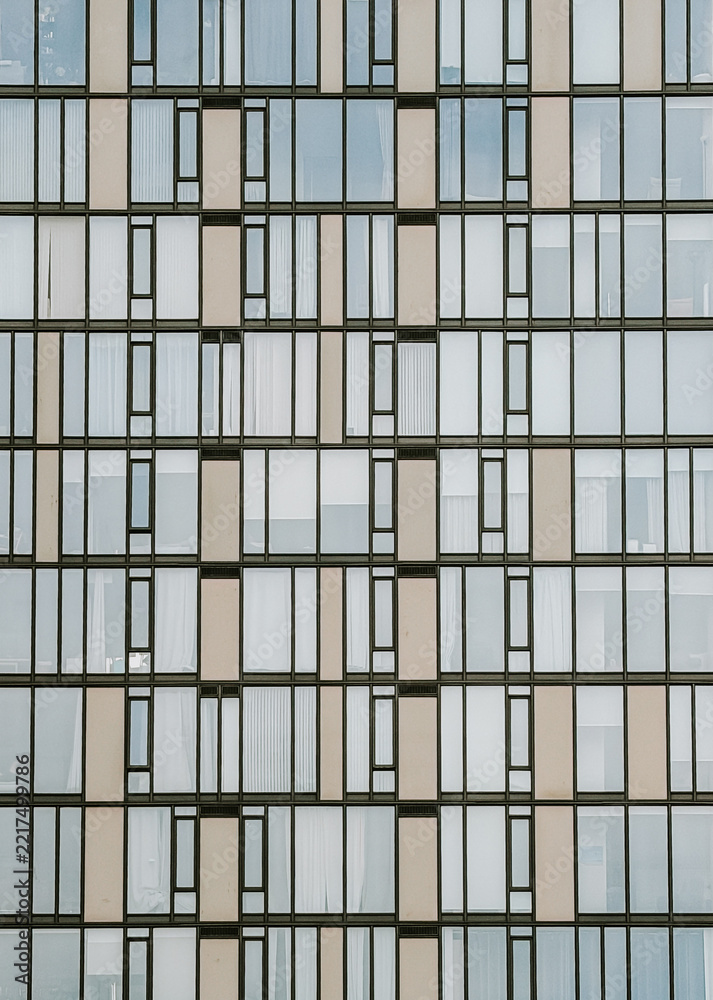 Fototapeta premium Modern building facade with geometric window pattern