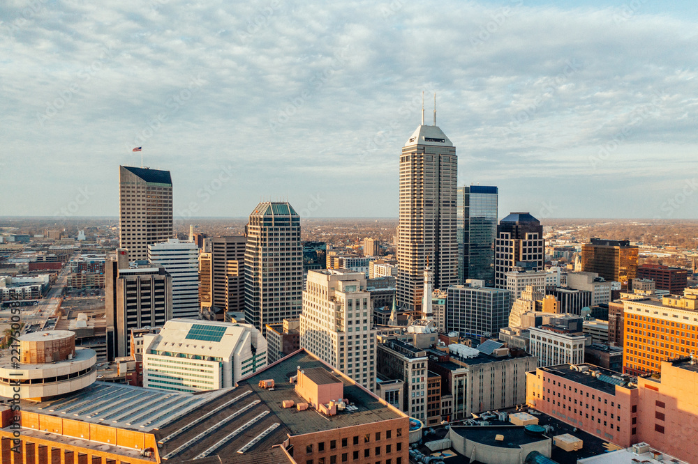 Fototapeta premium Elevated view across a dense downtown skyline in warm light.