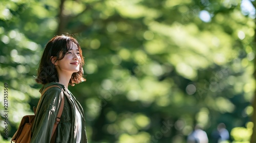Beautiful young asian woman walking in a green park