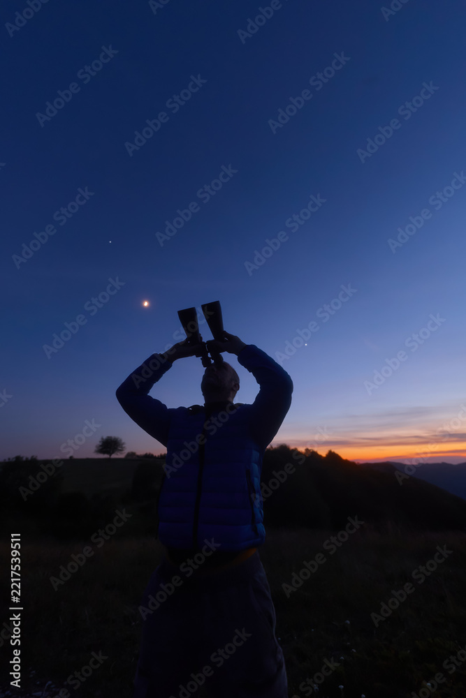 Fototapeta premium Amateur astronomer observing stars, planets and other celestial objects.