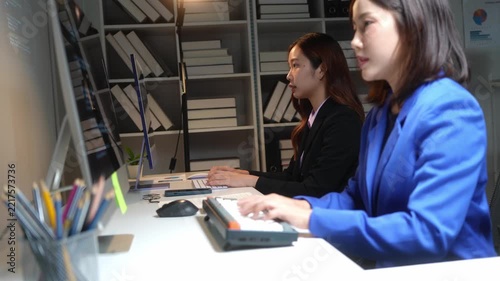 Two female programmers collaborating on code