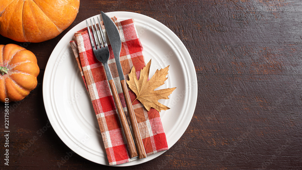 Fototapeta premium Autumn table setting with maple leaf on dark wooden background