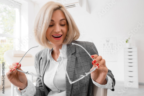 Vision correction and eye health, happy woman holding new prescription glasse...
