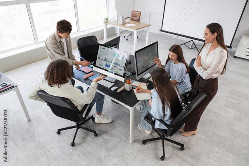 Team collaboration and financial analysis, diverse colleagues working togethe...