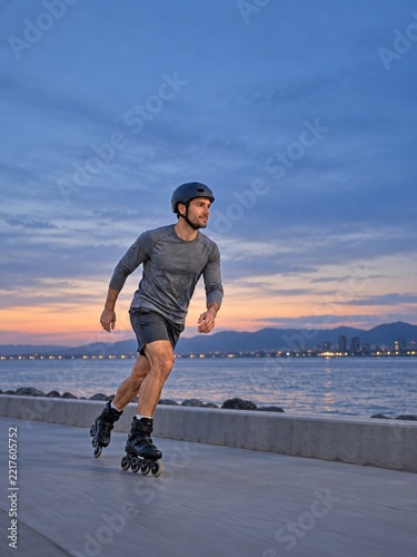 Male Inline Skater Along a Waterfront Path Beneath a Blue Dusk Sky