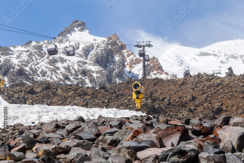 Sky Waka gondolas travel across the volcanic landscape of Mount Ruapehu at Whakapapa Ski Field, surrounded by rugged rock formations and snow-covered alpine peaks in New Zealand