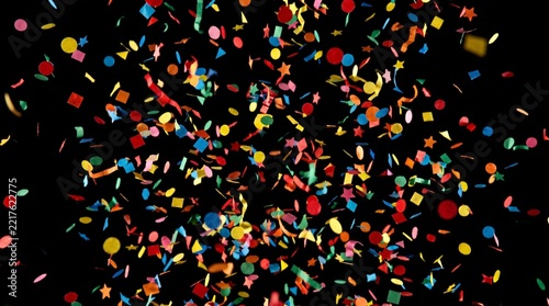 Obraz na plátně A festive and colorful party with flying neon confetti on a golden background