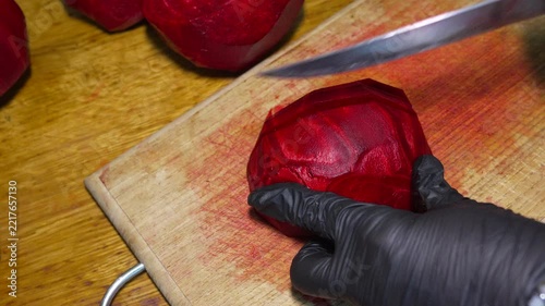Fresh beet slicing, organic vegetable preparation on wooden board. High-angle static shot.