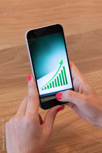Business planning scene with notebook, smartphone and rising graph, representing financial strategy, investment decisions, market growth and economic success.