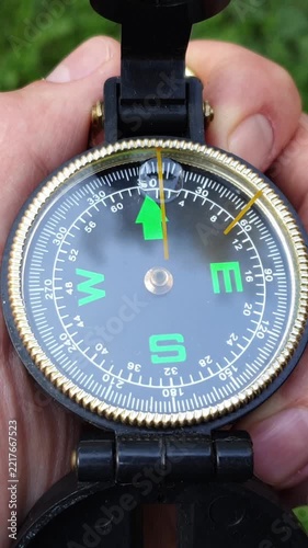 Person holding compass in hand for outdoor navigation