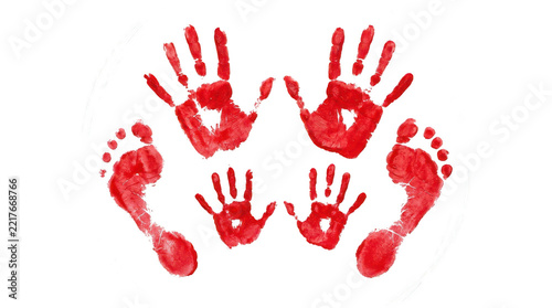 Red handprints and footprints of parents and children creating a family concept isolated on a white background