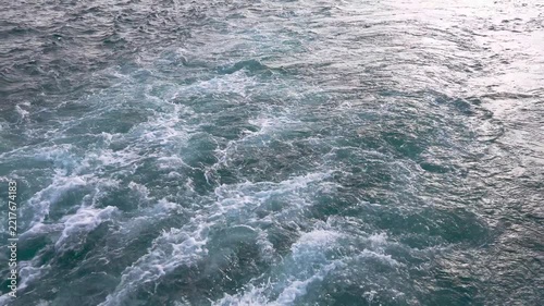 Close up view of the wake, back waves of a sailing boat.