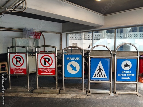 Row of Diverse Parking and Traffic Signage in a Parking Garage