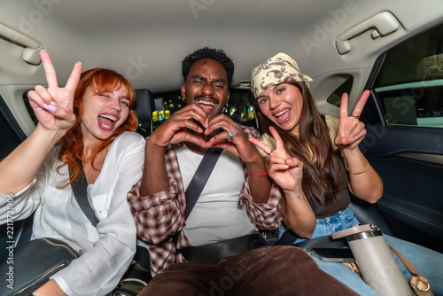 Diverse friends enjoying milan nightlife traveling in car