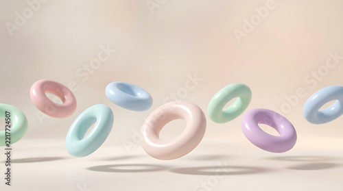Row of pastel 3D rings floating above light floor