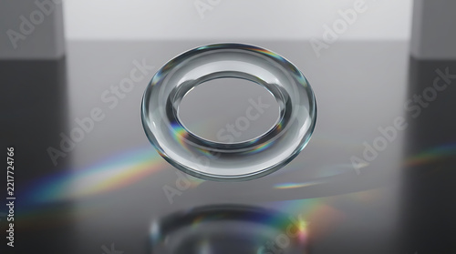 Transparent glass torus floating above dark floor