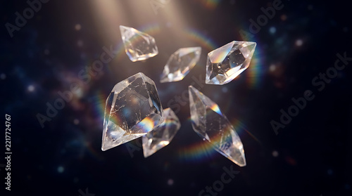 Clear quartz crystal shards floating in light beam in space