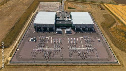 Aerial view of the Viking Link HVDC Converter Station, featuring large industrial buildings and electrical infrastructure surrounded by agricultural fields, Donington, England, United Kingdom.