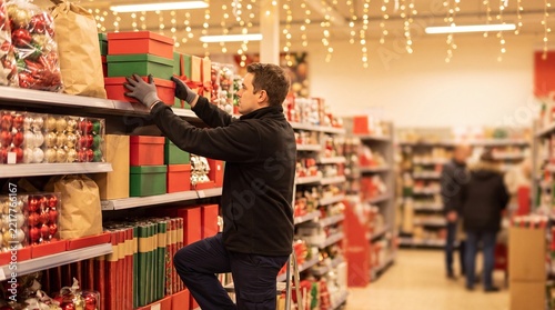 Retail Store Atmosphere, A store employee restocks festive holiday products in a warm, inviting retail space