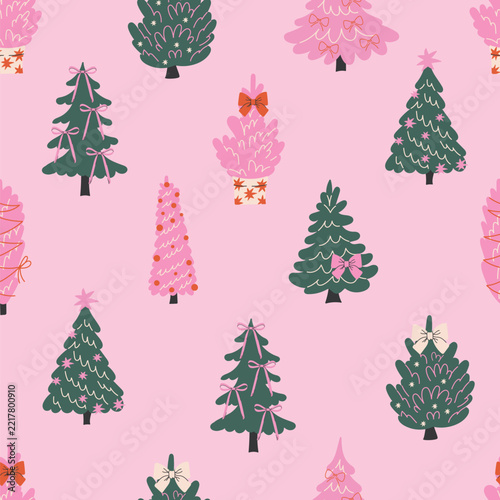 Seamless vector pattern with pink Christmas trees scattered on a soft pastel pink background.