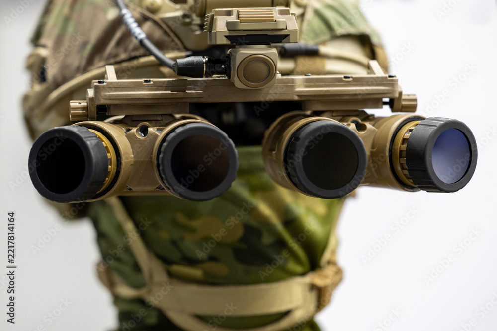 Fototapeta premium Military night vision goggles mounted on tactical combat helmet. Special forces panoramic four lens optical device shown in close frontal view.