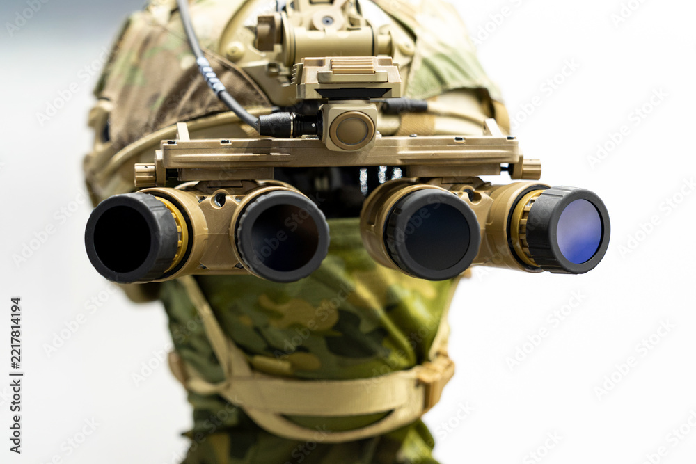 Fototapeta premium Military night vision goggles mounted on tactical helmet in close frontal perspective. Panoramic four lens optical device attached to special forces combat headgear.