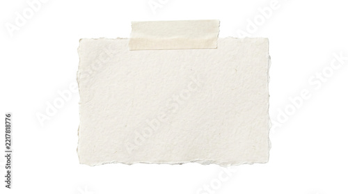 Fotografie Textured handmade white paper note with rough deckle edges secured by adhesive t