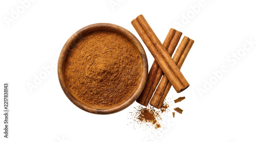 Obraz na plátně Cinnamon powder in a wooden bowl with cinnamon sticks on top