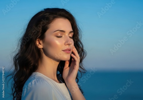 Woman touching face with eyes closed in calm mood