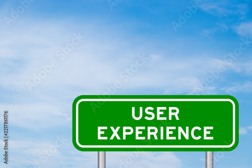 Green color transportation sign with word user experience on blue sky with white cloud background