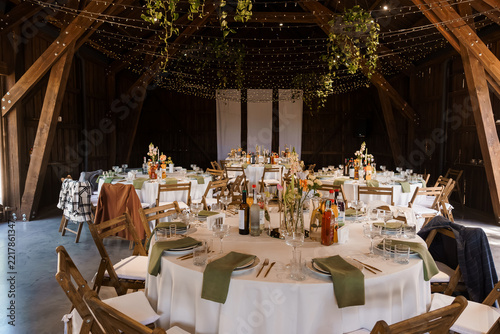 Wedding Reception Venue Decor with White Linens in Rustic Wooden Barn