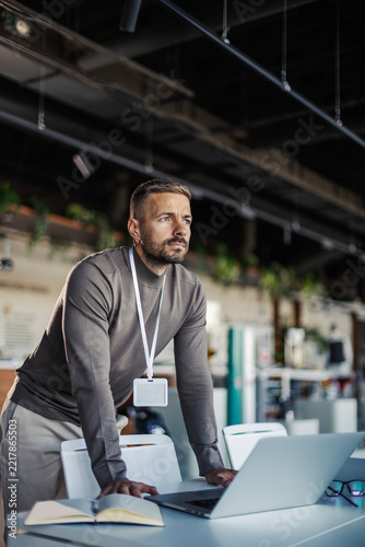 Professional man thinking at office workstation, planning new business strategies