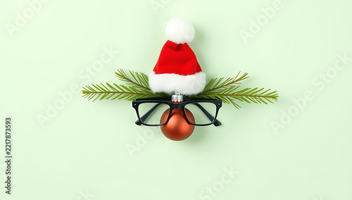 Creative christmas reindeer face made from glasses and ornaments on pastel background