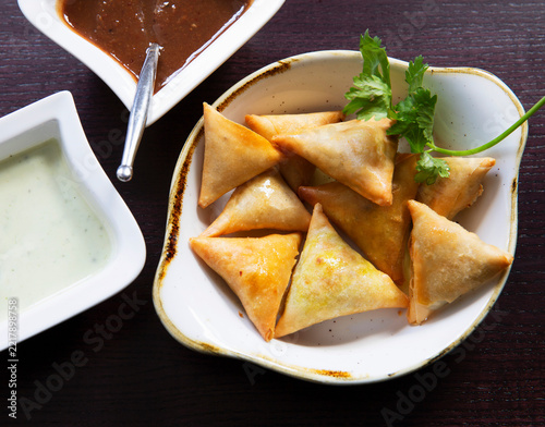 Samosas filled with lentils and lamb with dipping sauces